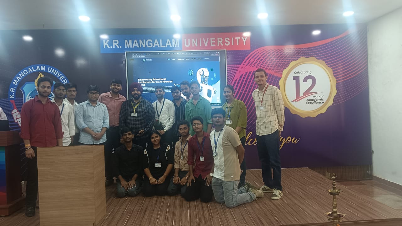 Group of students and mentors posing on stage at K.R. Mangalam University after the session
